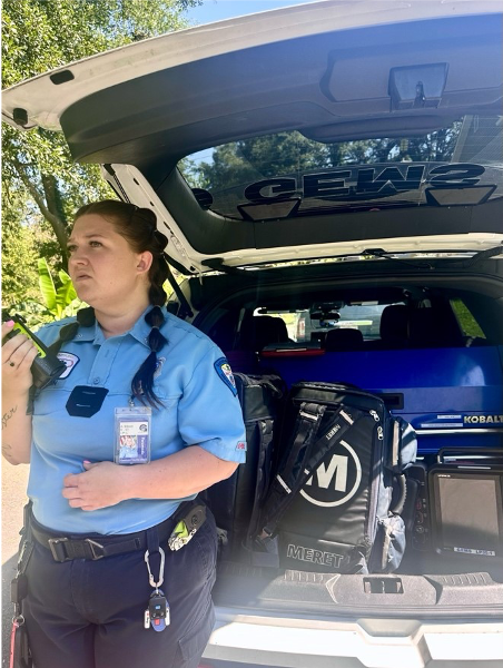 Paramedic Aleta Ellison standing in front of an open Paramedic vehicle trunk.